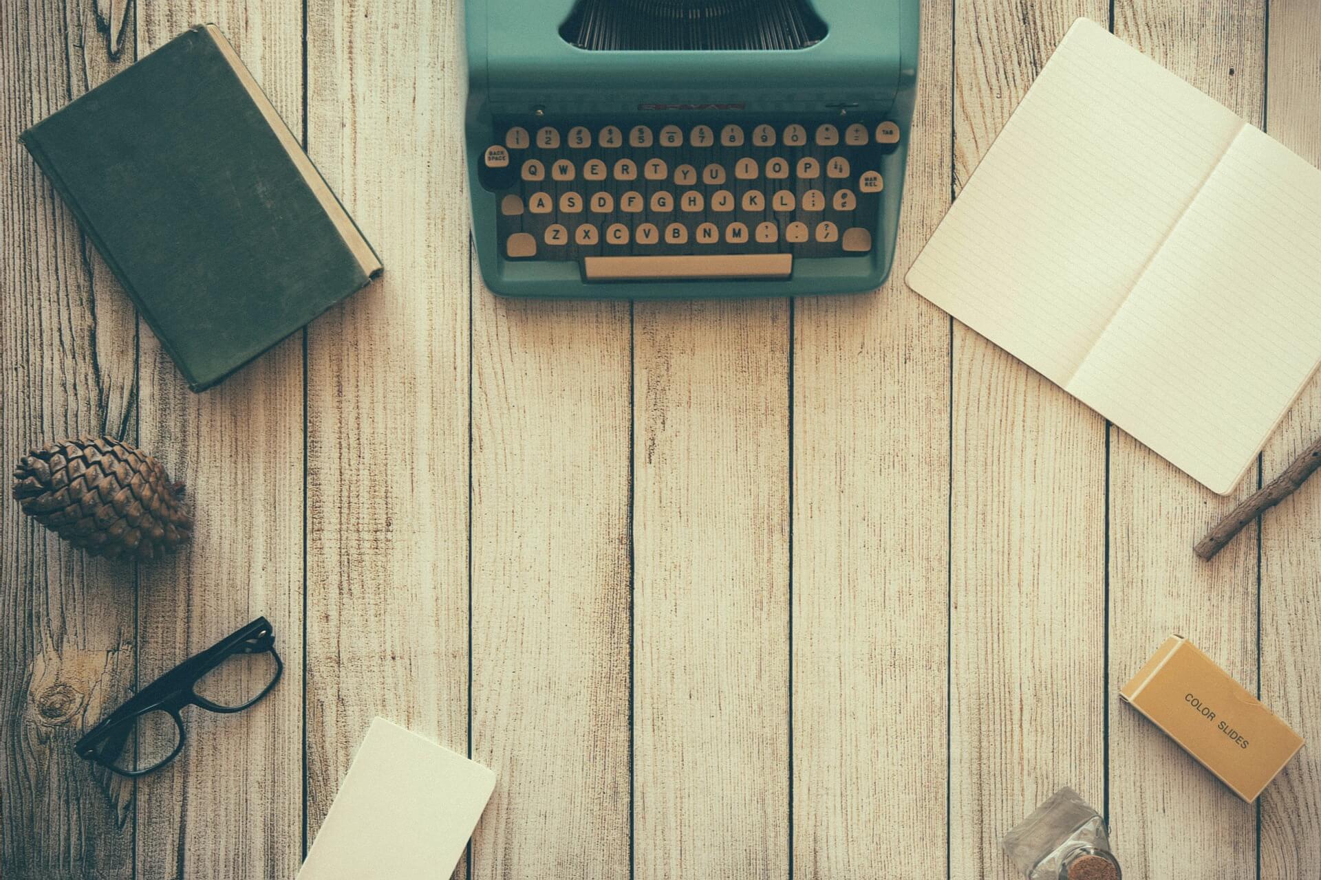 A desk with office equipment for writing a comparative essay